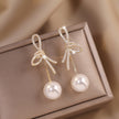 Golden Bowknot Pearl Zirconia Metal Earrings / Ruchi